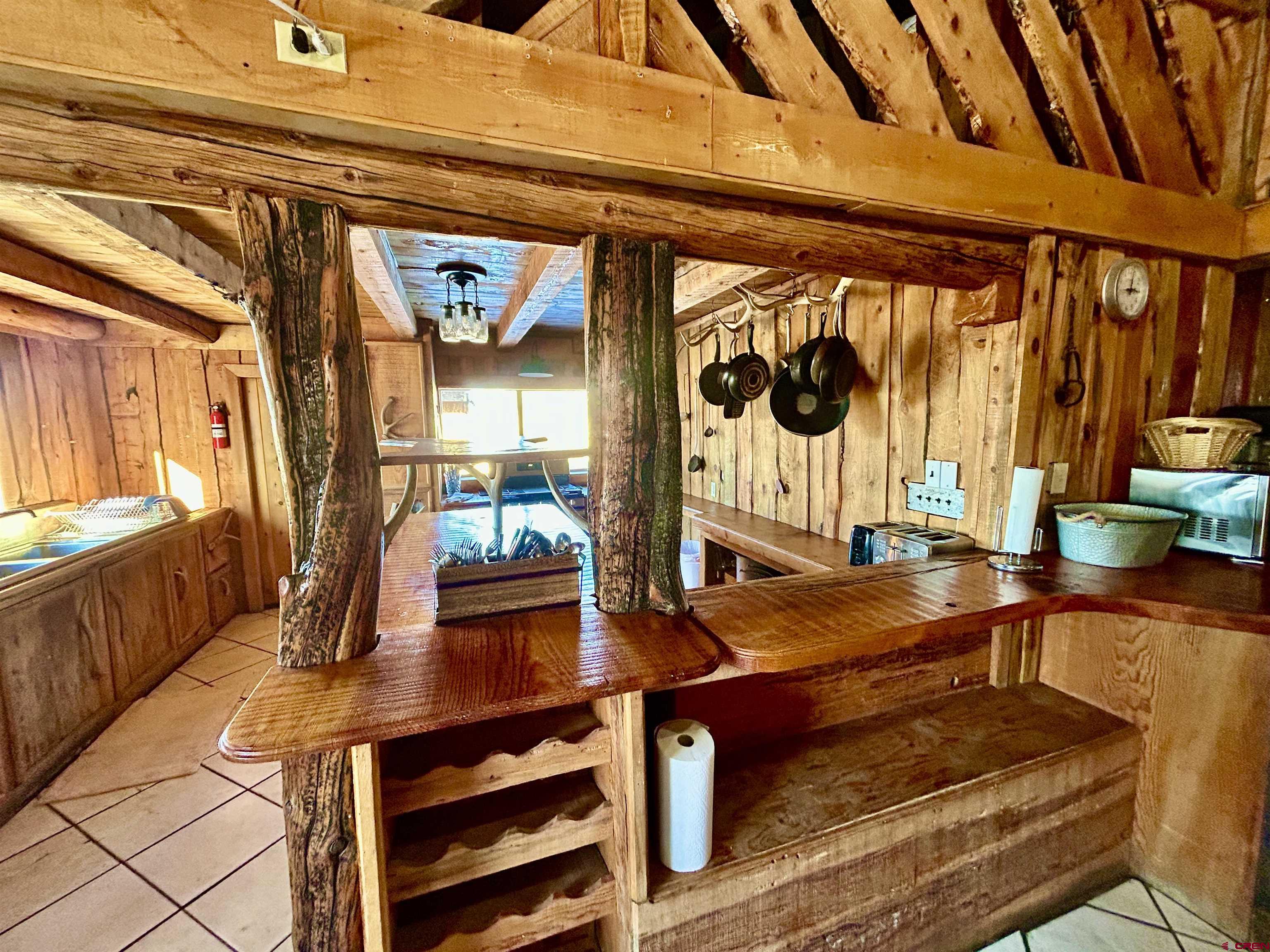 16 Arellano Road, Unit TRES CUERDAS LODGE Amalia, NM 87512 - Photo 21 of 45 a reading room with furniture and wooden floor