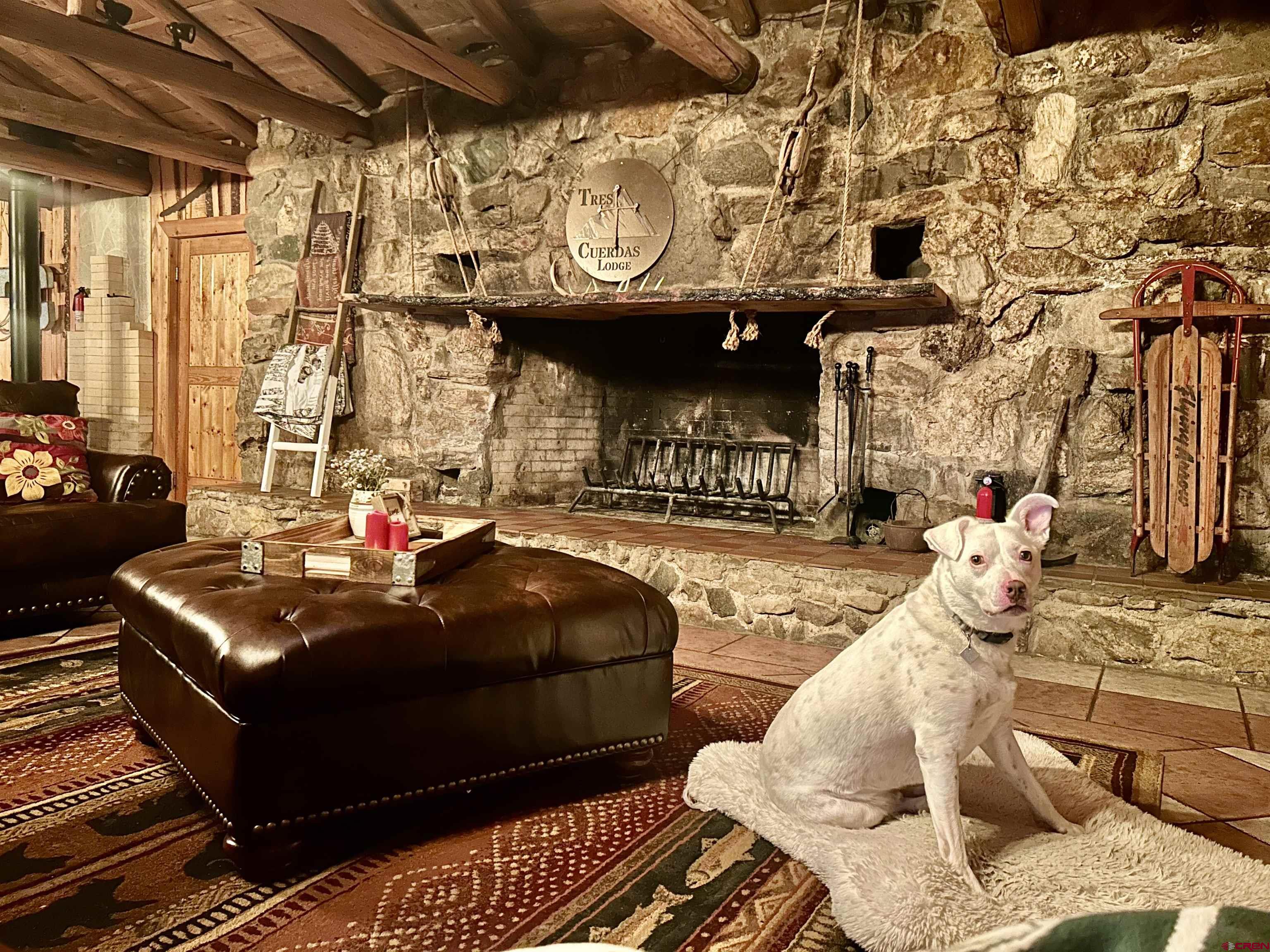 16 Arellano Road, Unit TRES CUERDAS LODGE Amalia, NM 87512 - Photo 22 of 45 a living room with furniture and a fireplace