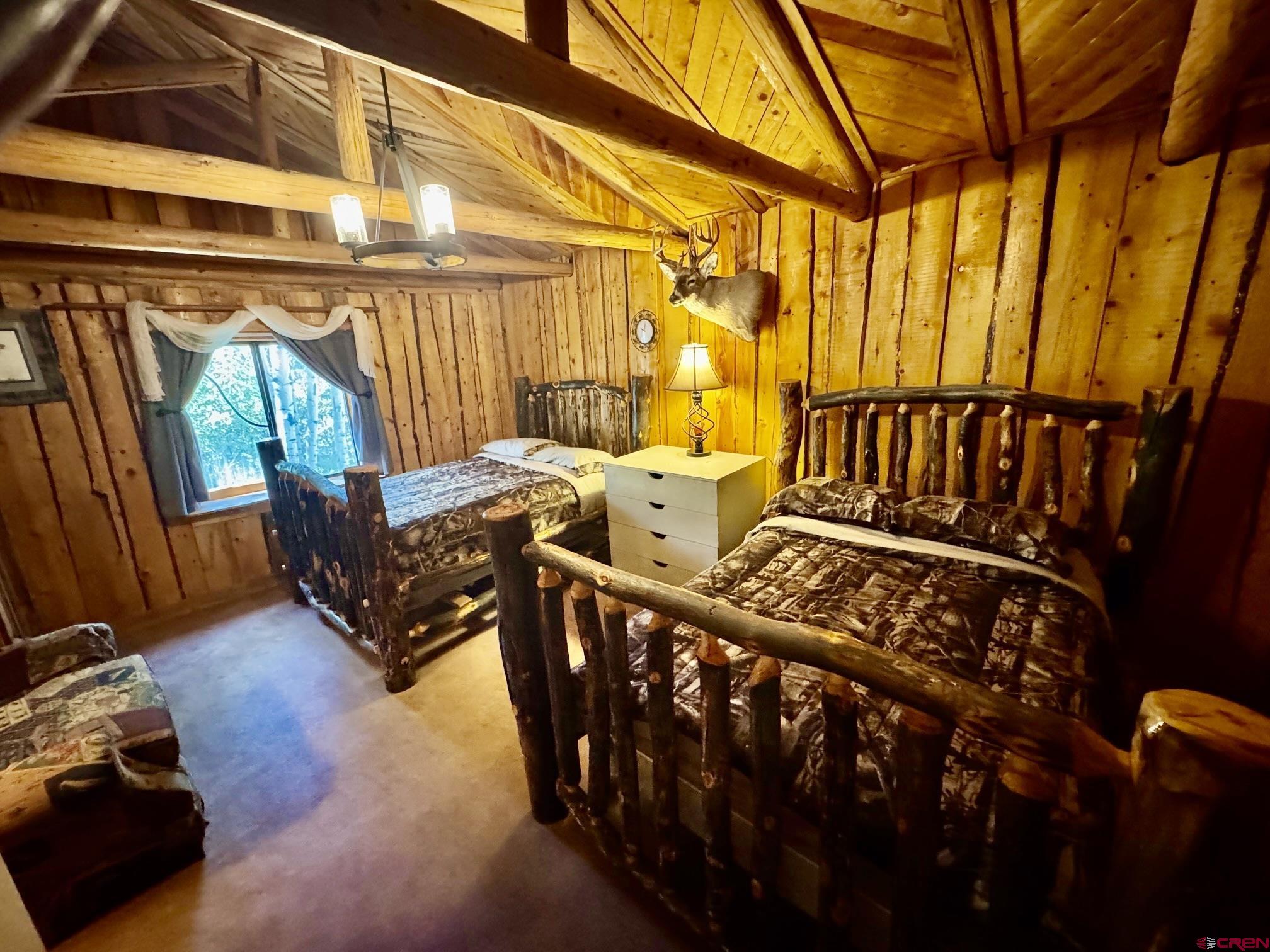16 Arellano Road, Unit TRES CUERDAS LODGE Amalia, NM 87512 - Photo 31 of 45 a view of a chairs on the deck