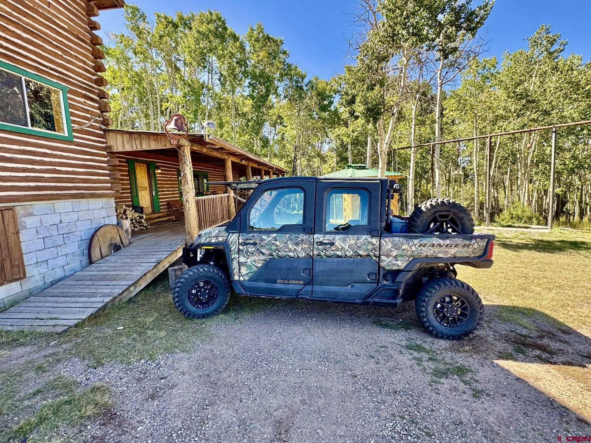 16 Arellano Road, Unit TRES CUERDAS LODGE Amalia, NM 87512 - Photo 32 of 45 a view of a house with a backyard and a patio