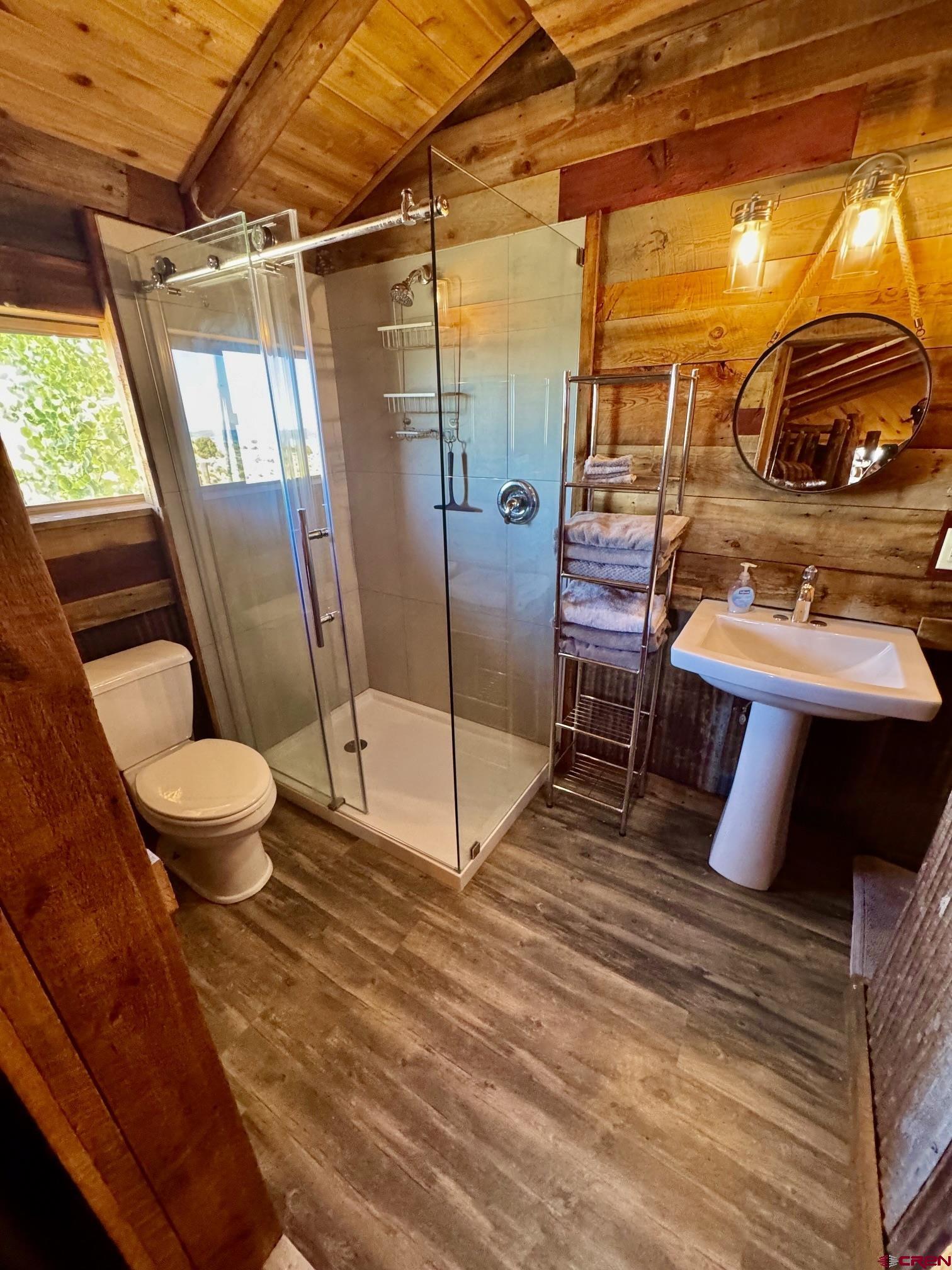 16 Arellano Road, Unit TRES CUERDAS LODGE Amalia, NM 87512 - Photo 33 of 45 a bathroom with a sink and mirror
