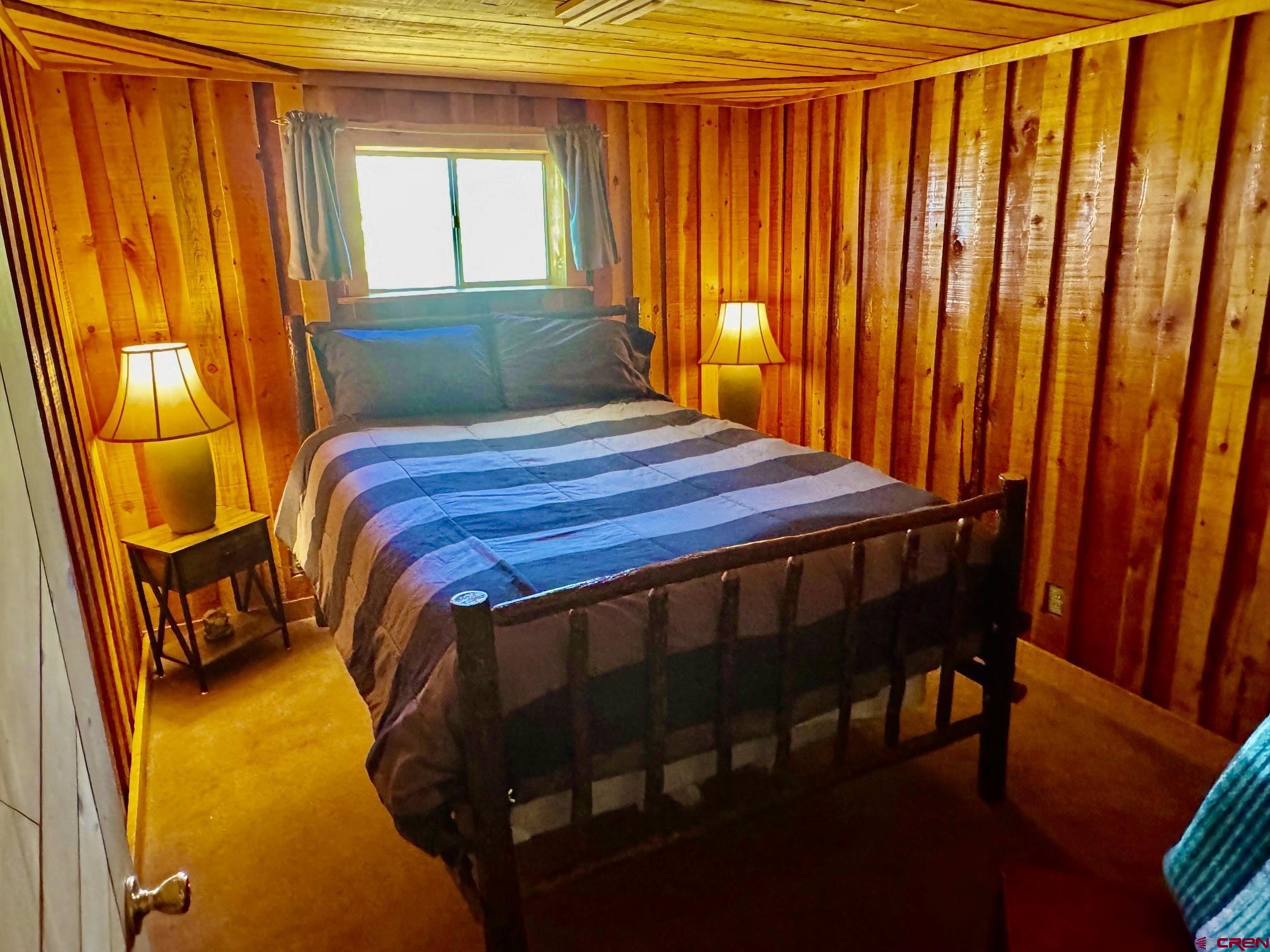 16 Arellano Road, Unit TRES CUERDAS LODGE Amalia, NM 87512 - Photo 34 of 45 a bedroom with a bed and a window
