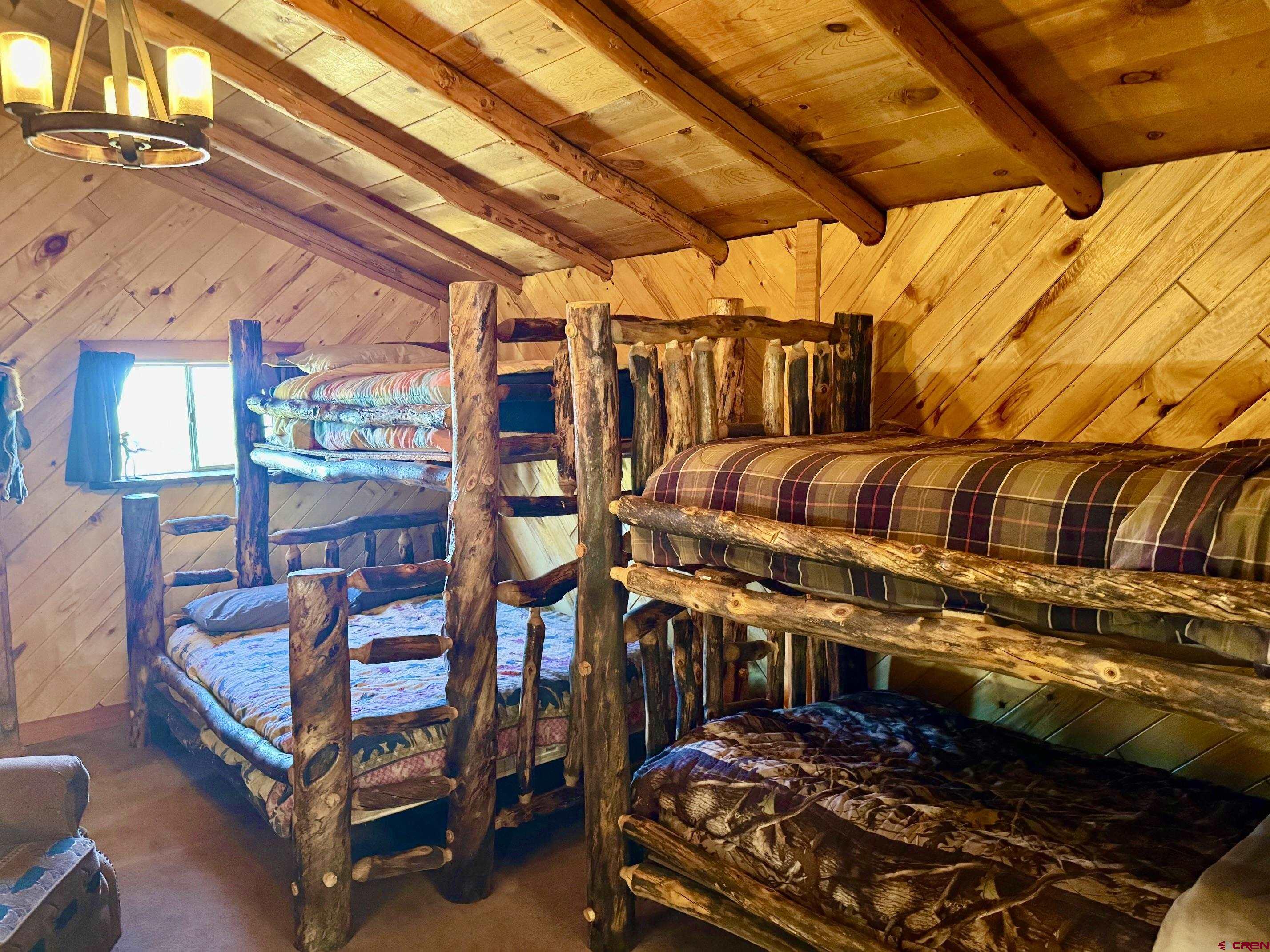 16 Arellano Road, Unit TRES CUERDAS LODGE Amalia, NM 87512 - Photo 41 of 45 a view of a chairs with wooden floor