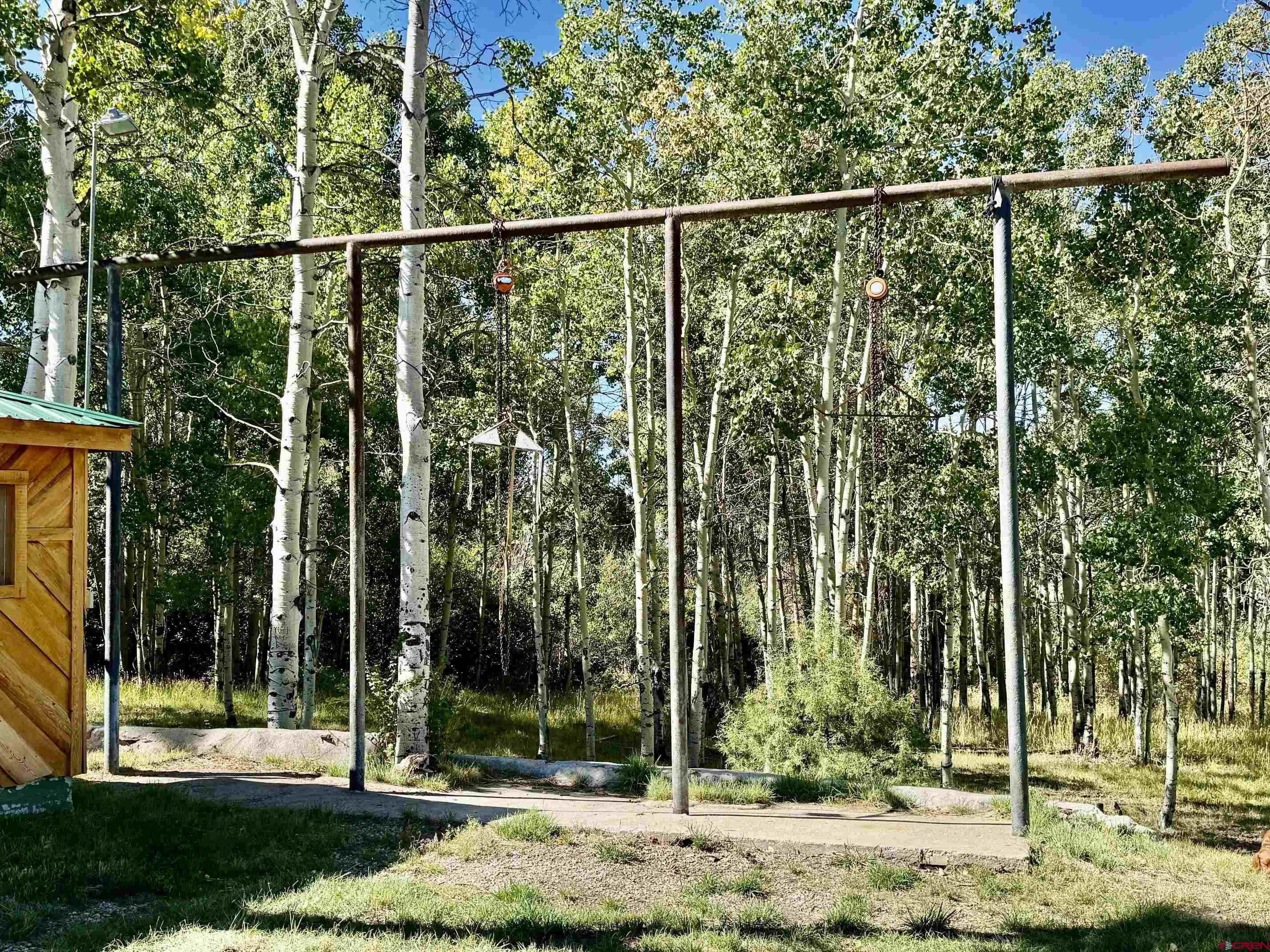 16 Arellano Road, Unit TRES CUERDAS LODGE Amalia, NM 87512 - Photo 44 of 45 a view of a yard with a tree