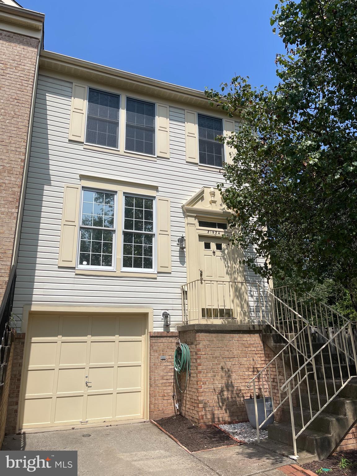 21924 Greentree Terrace Sterling, VA 20164 - Photo 1 of 29 a front view of a house with a garage