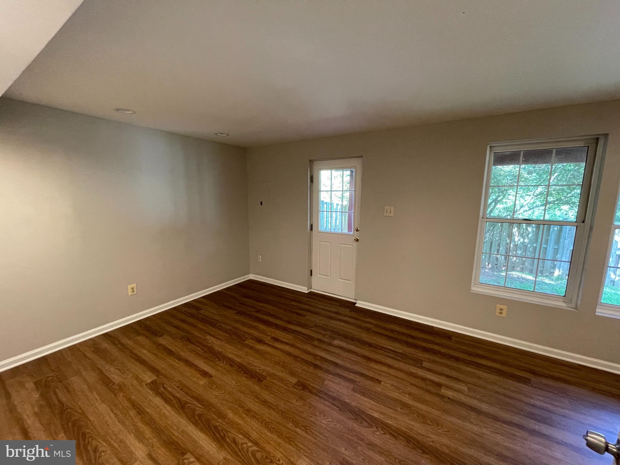 21924 Greentree Terrace Sterling, VA 20164 - Photo 13 of 29 a view of an empty room with wooden floor and a window