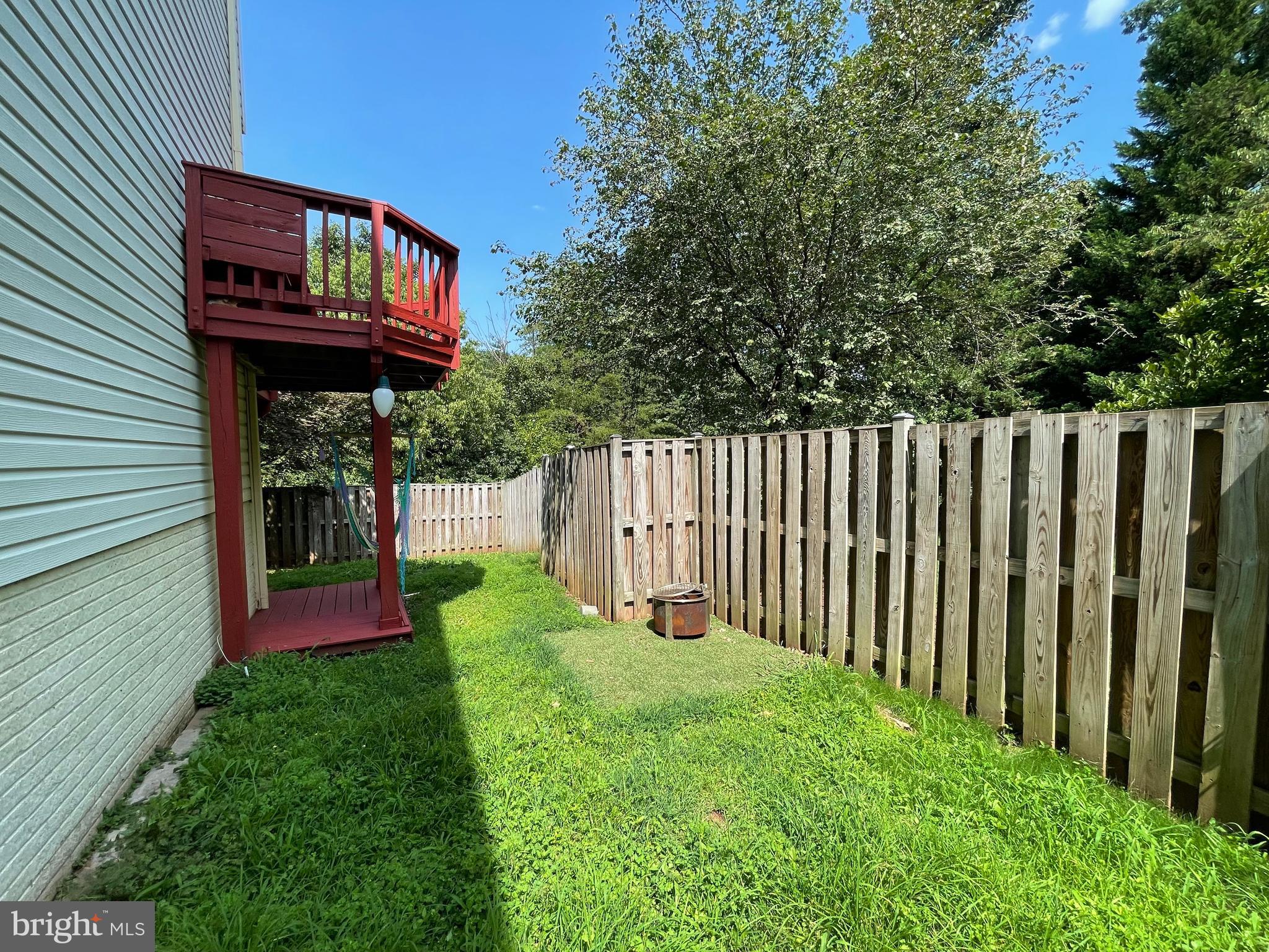 21924 Greentree Terrace Sterling, VA 20164 - Photo 18 of 29 a view of a backyard with wooden fence and trees