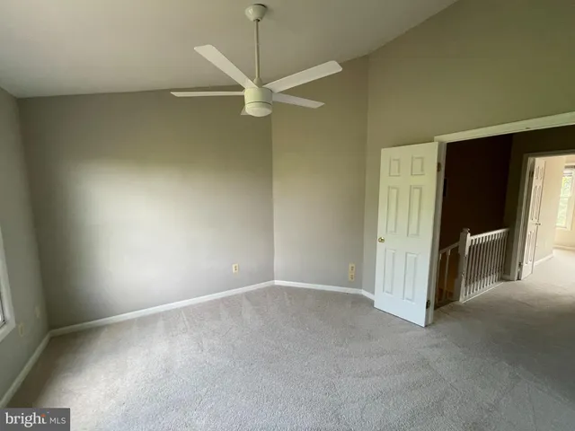 an empty room with a empty space and a ceiling fan
