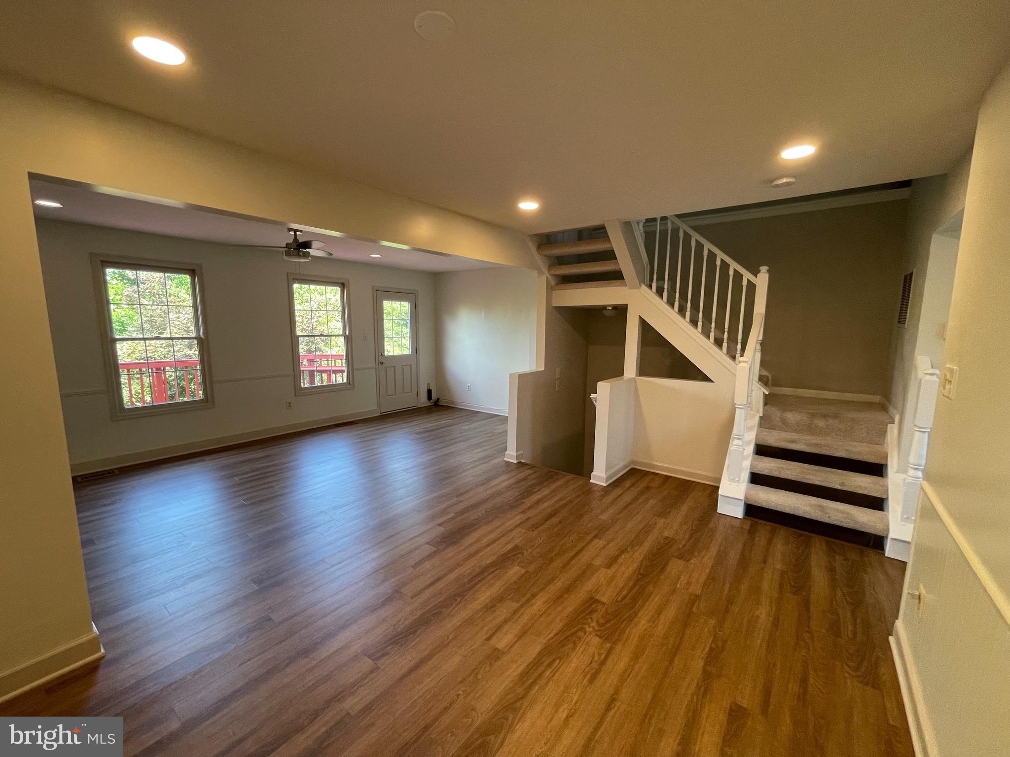 21924 Greentree Terrace Sterling, VA 20164 - Photo 6 of 29 an empty room with wooden floor and windows