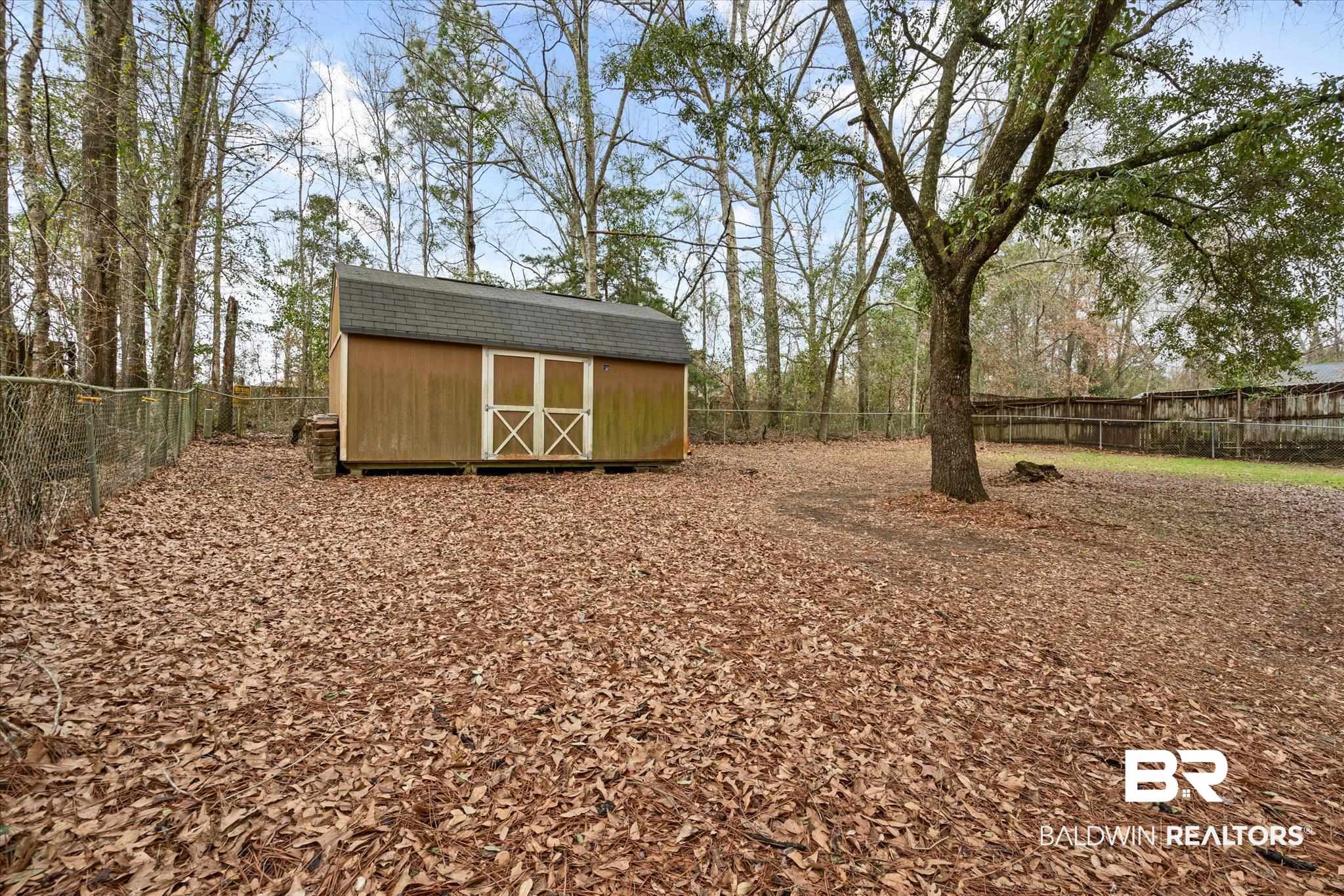 3541 Winston Drive Semmes, AL 36575 - Photo 19 of 20 View of yard with an outbuilding, a fenced backyard, and a storage shed
