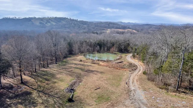 a backyard of a house with a yard and outdoor seating