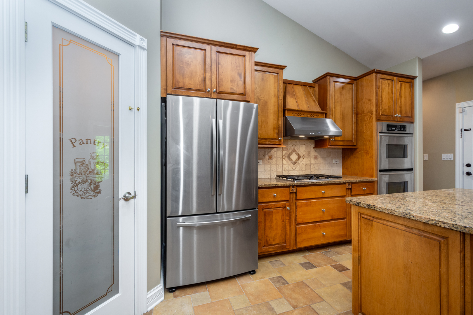 10303 Fox Bluff Lane Spring Grove, IL 60081 - Photo 12 of 44 a kitchen with stainless steel appliances granite countertop a refrigerator a stove and a sink