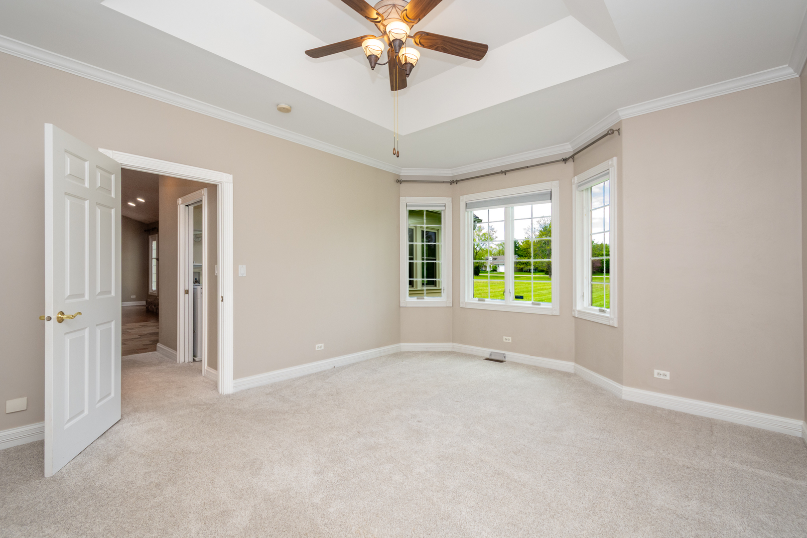 10303 Fox Bluff Lane Spring Grove, IL 60081 - Photo 15 of 44 a view of an empty room with window and a ceiling fan