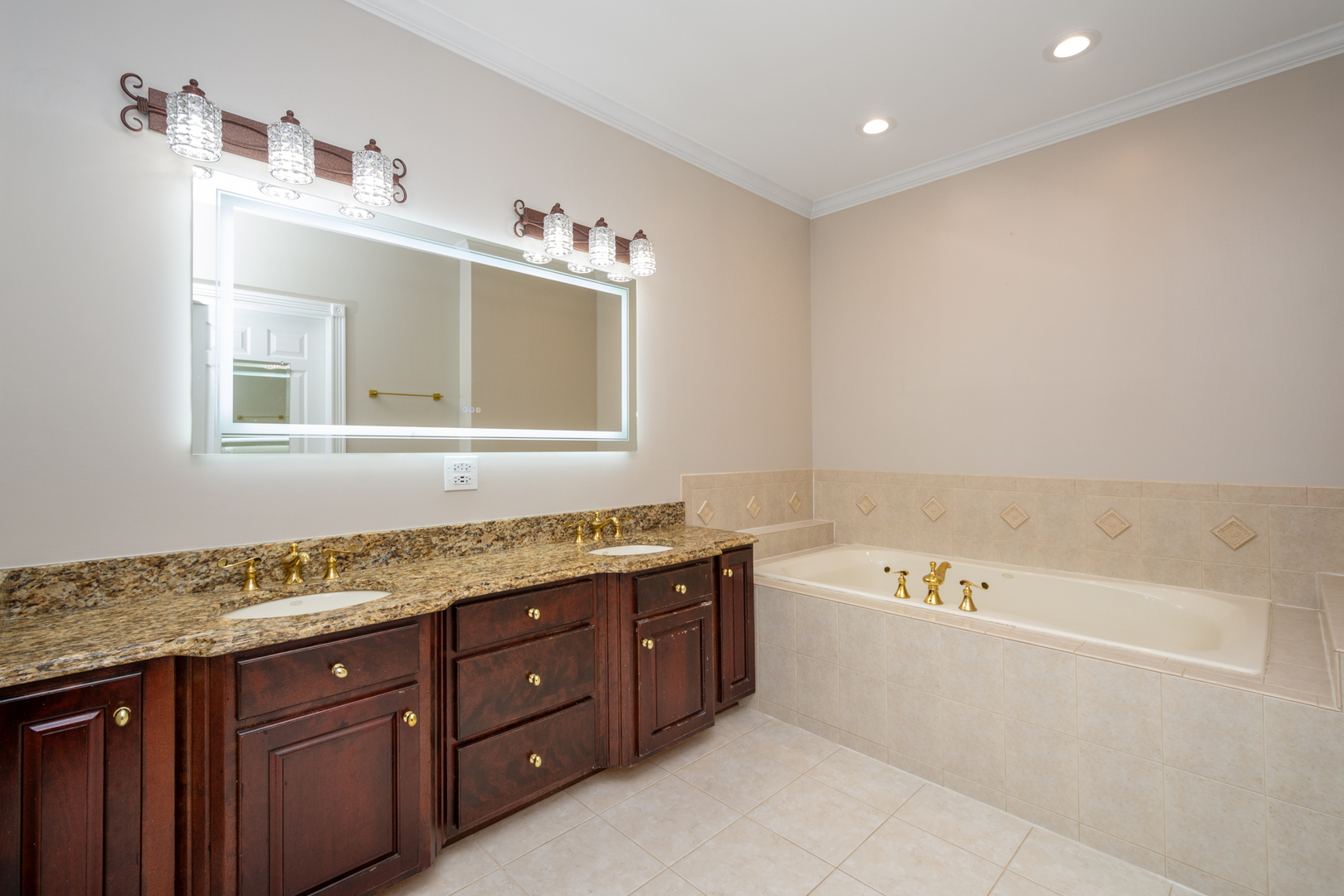 10303 Fox Bluff Lane Spring Grove, IL 60081 - Photo 16 of 44 a spacious bathroom with a granite countertop tub sink and mirror