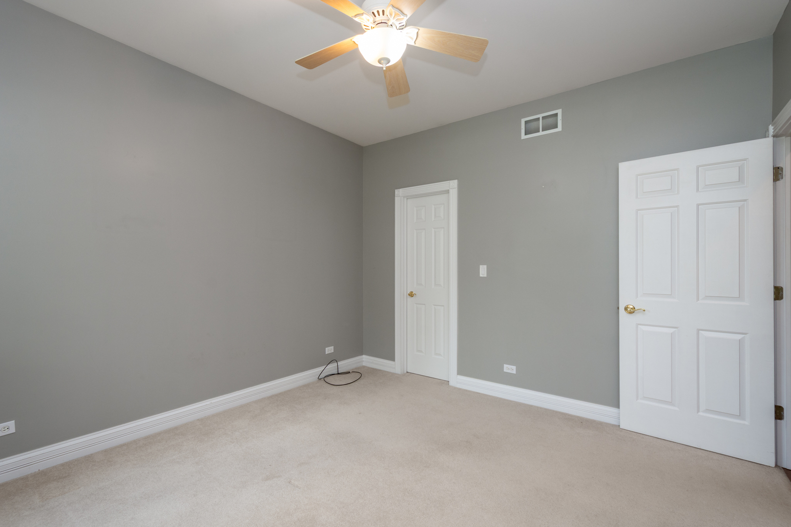 10303 Fox Bluff Lane Spring Grove, IL 60081 - Photo 21 of 44 an empty room with a chandelier fan and closet area
