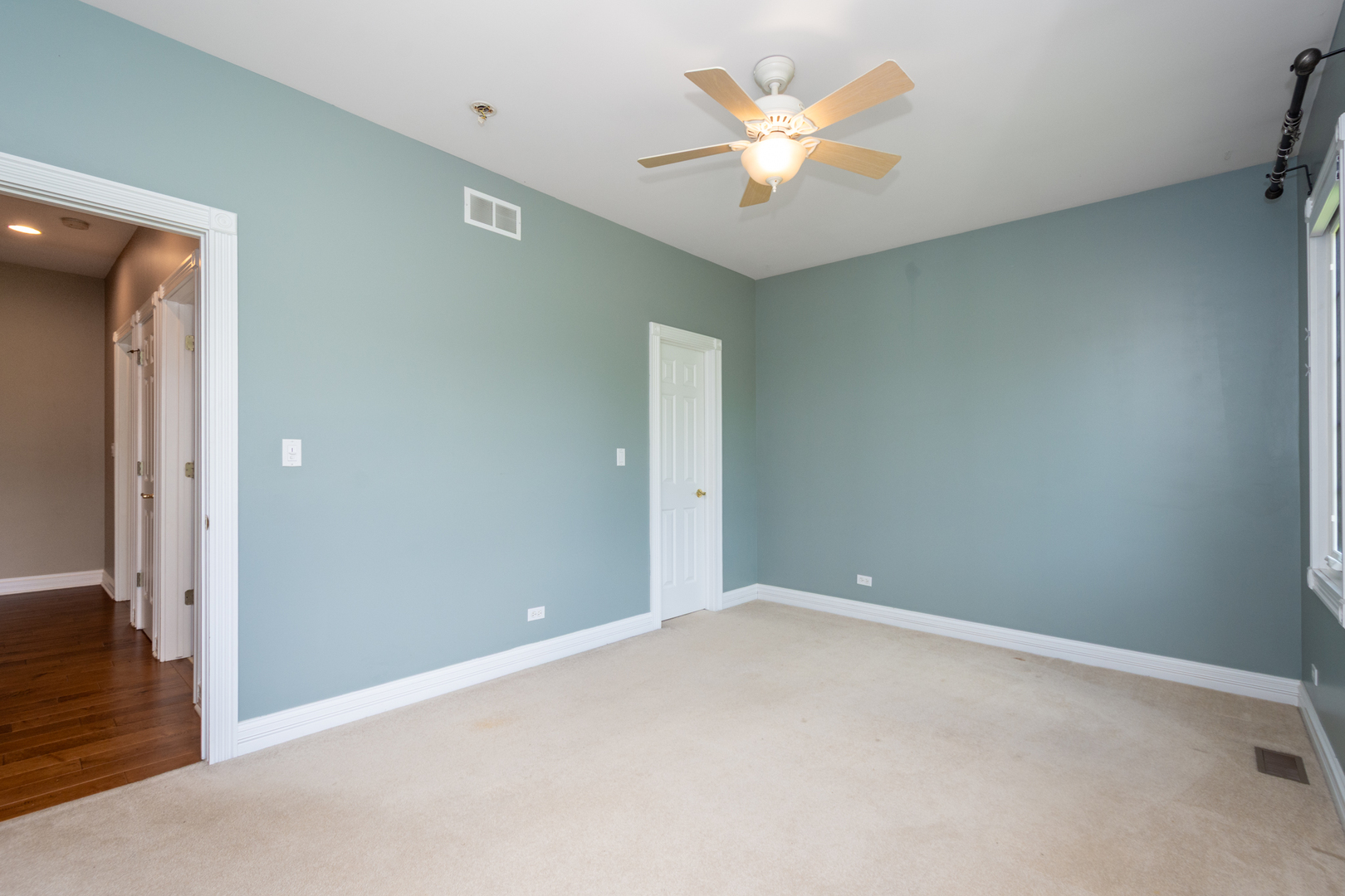10303 Fox Bluff Lane Spring Grove, IL 60081 - Photo 24 of 44 a view of an empty room with a chandelier fan