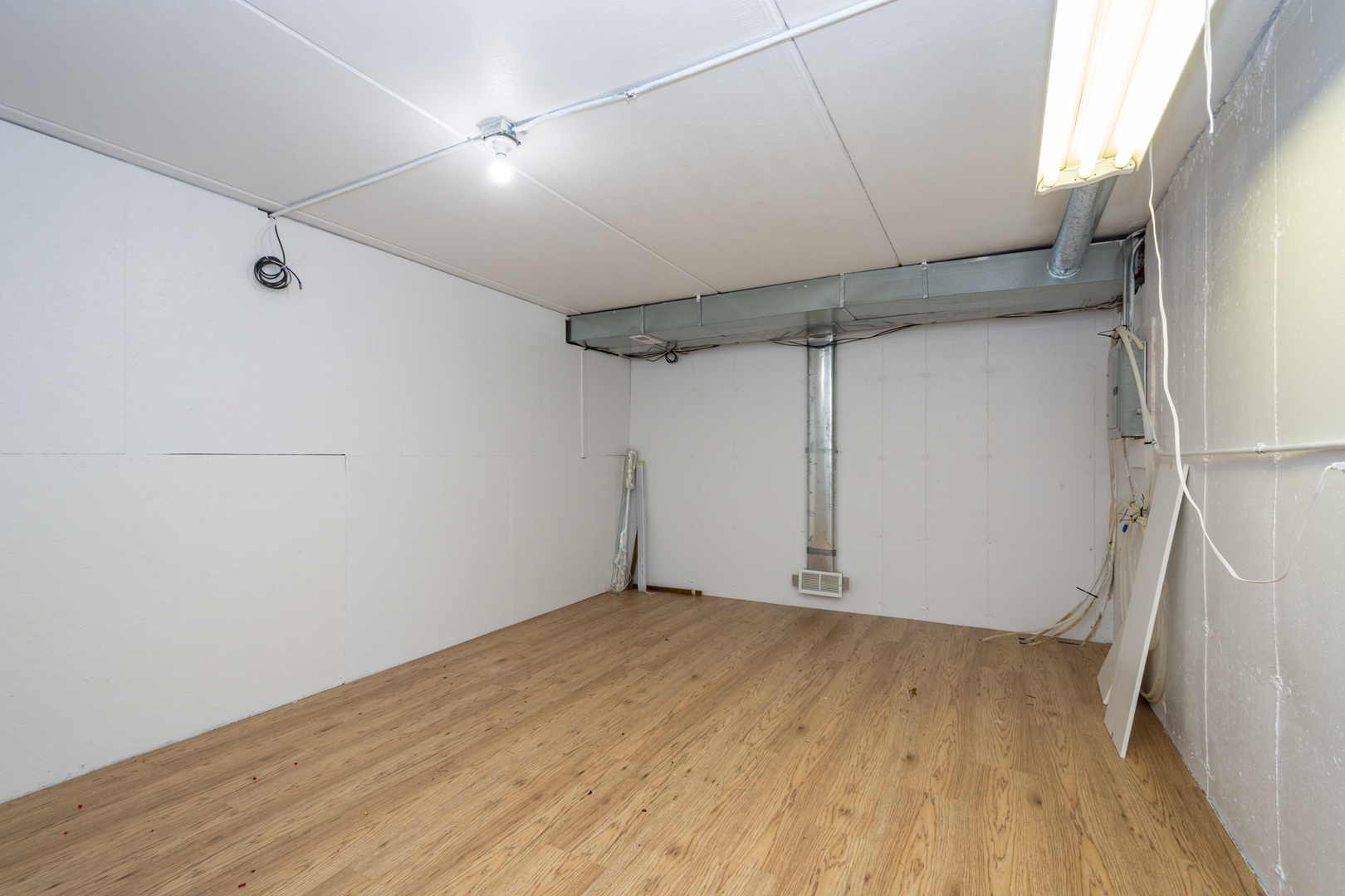 10303 Fox Bluff Lane Spring Grove, IL 60081 - Photo 32 of 44 an empty room with wooden floor and fan