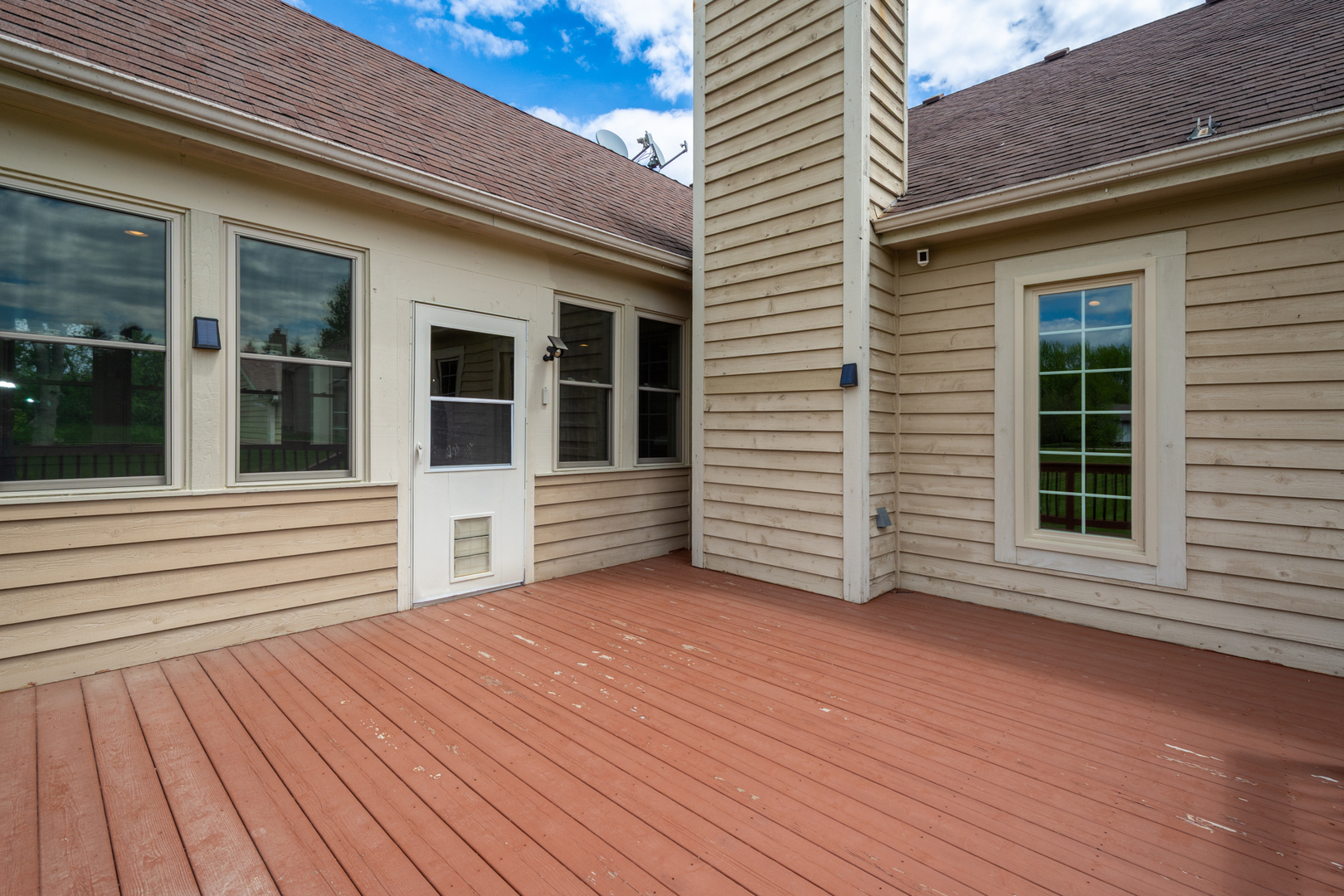 10303 Fox Bluff Lane Spring Grove, IL 60081 - Photo 37 of 44 a view of a house with deck and floor to ceiling window