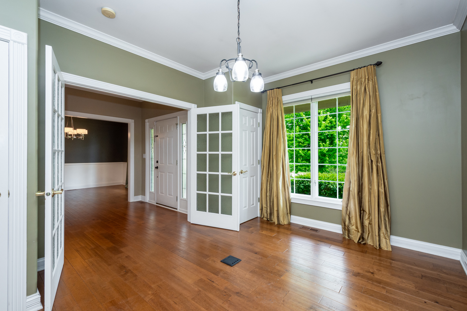 10303 Fox Bluff Lane Spring Grove, IL 60081 - Photo 5 of 44 a view of an empty room with wooden floor and a window