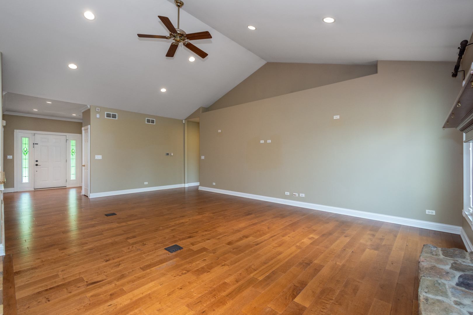 10303 Fox Bluff Lane Spring Grove, IL 60081 - Photo 6 of 44 an empty room with wooden floor and a ceiling fan