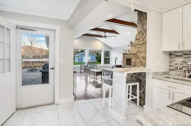 a view of a kitchen with furniture and floor to ceiling window