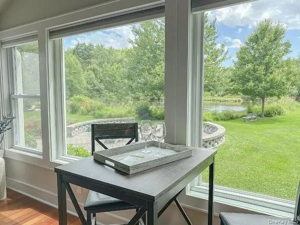 a view of a room with a table and chairs