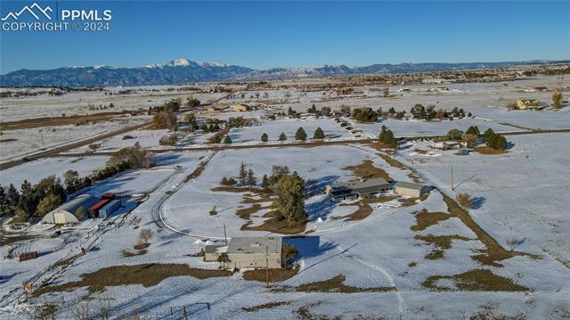 6605 Rio Road Peyton, CO 80831 - Photo 7 of 14 Snowy aerial view with a mountain view