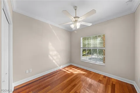 an empty room with a window and wooden floor