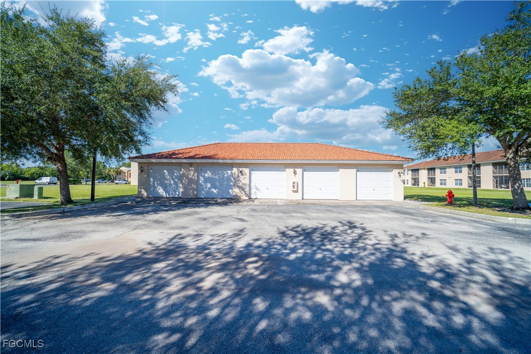 4160 Castilla Circle, Unit 106 Fort Myers, FL 33916 - Photo 26 of 37 a front view of a house with a yard and garage