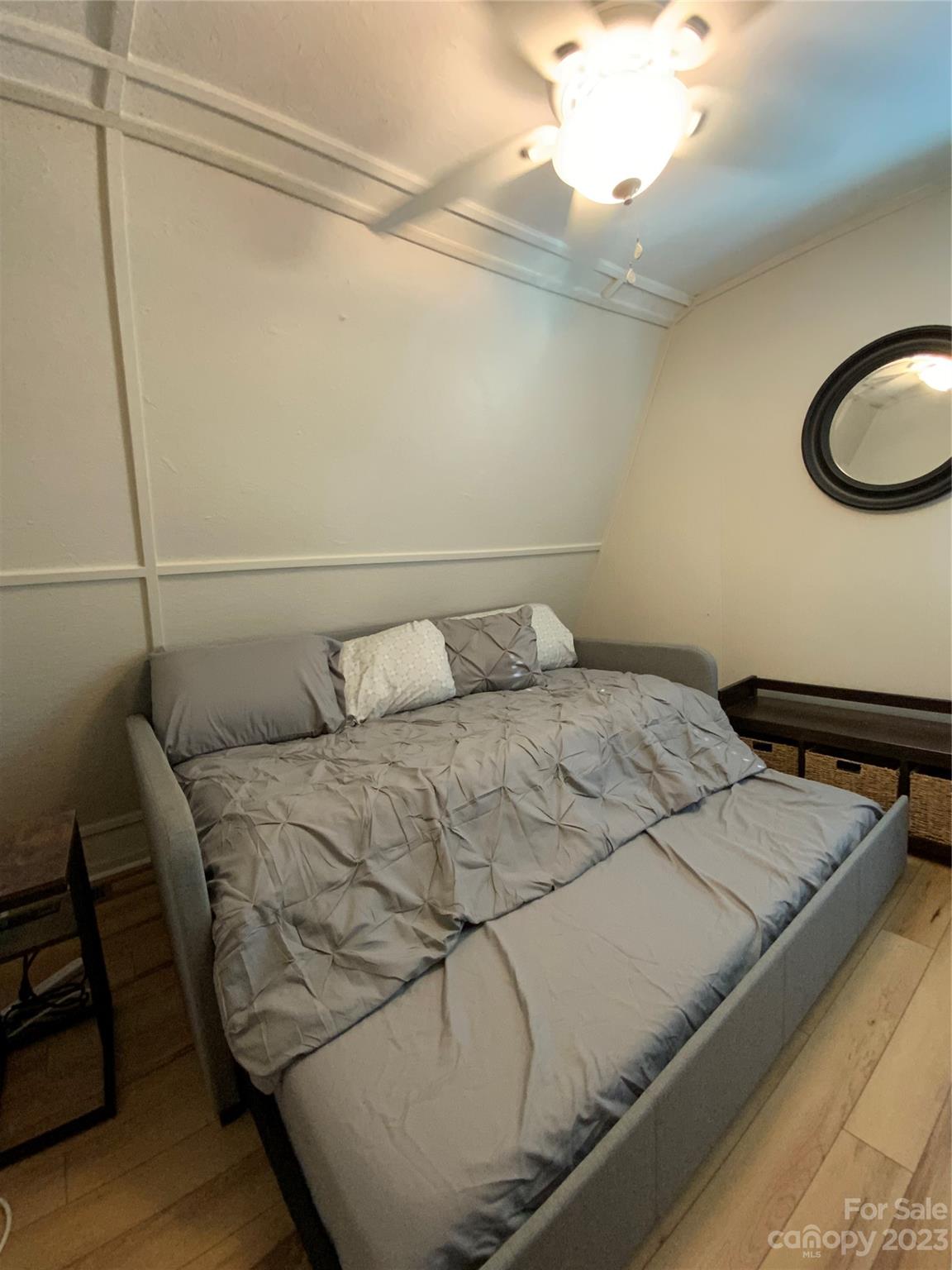 281 Spring Water Drive Brevard, NC 28712 - Photo 11 of 14 a bedroom with a bed and a chandelier