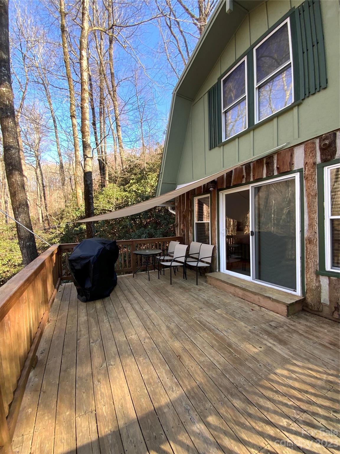 281 Spring Water Drive Brevard, NC 28712 - Photo 6 of 14 a view of a house with a barbeque and wooden floor
