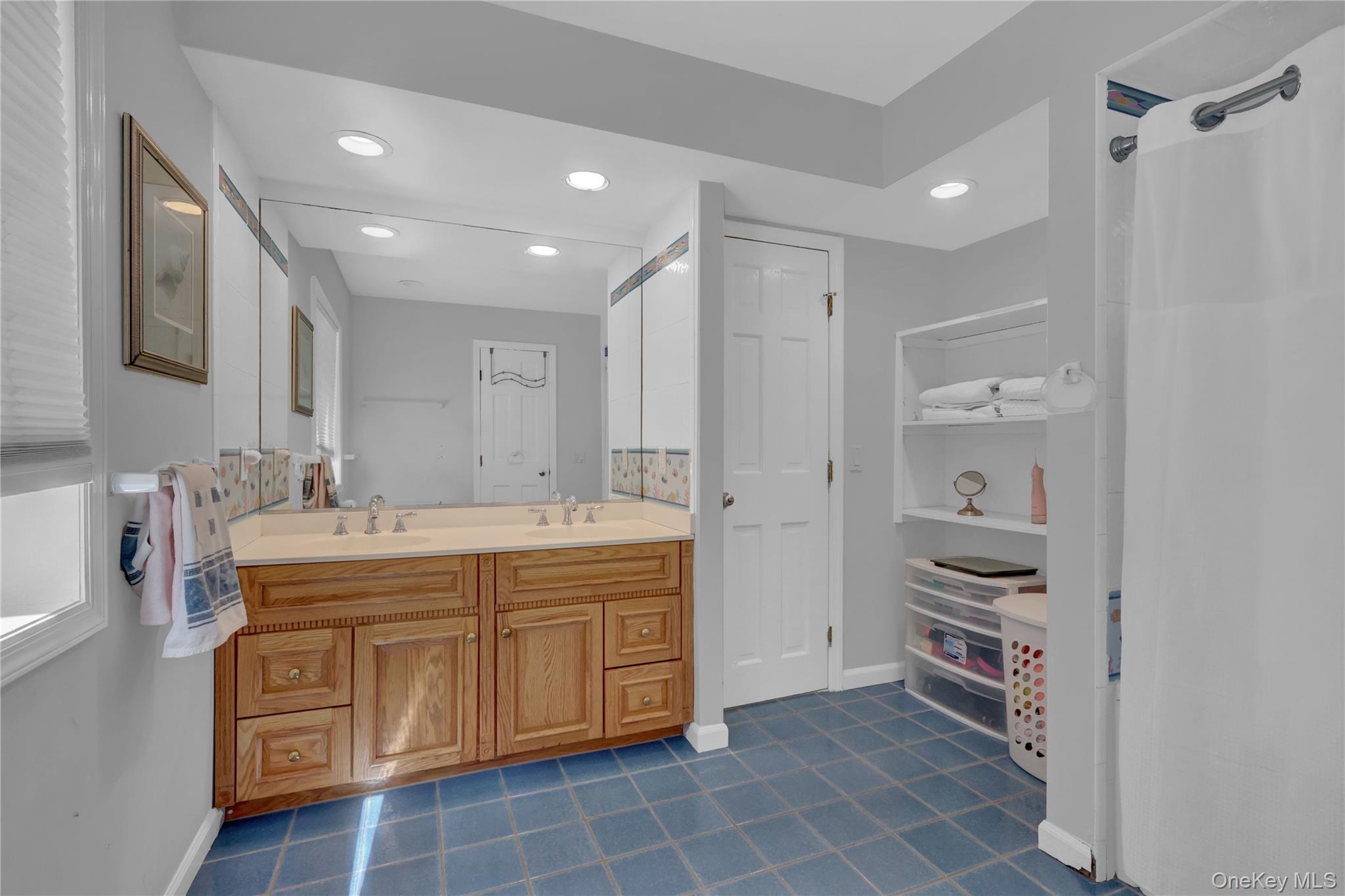 111 Old Field Road Setauket, NY 11733 - Photo 21 of 47 a bathroom with a double vanity sink a mirror and a shower