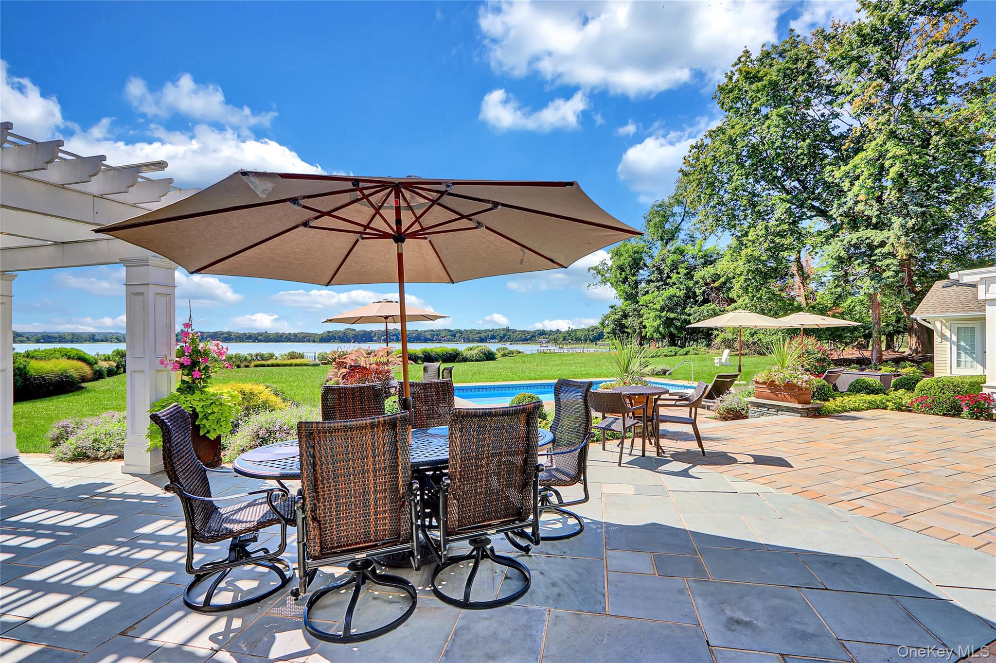 111 Old Field Road Setauket, NY 11733 - Photo 27 of 47 a view of an outdoor sitting area with chairs and umbrella