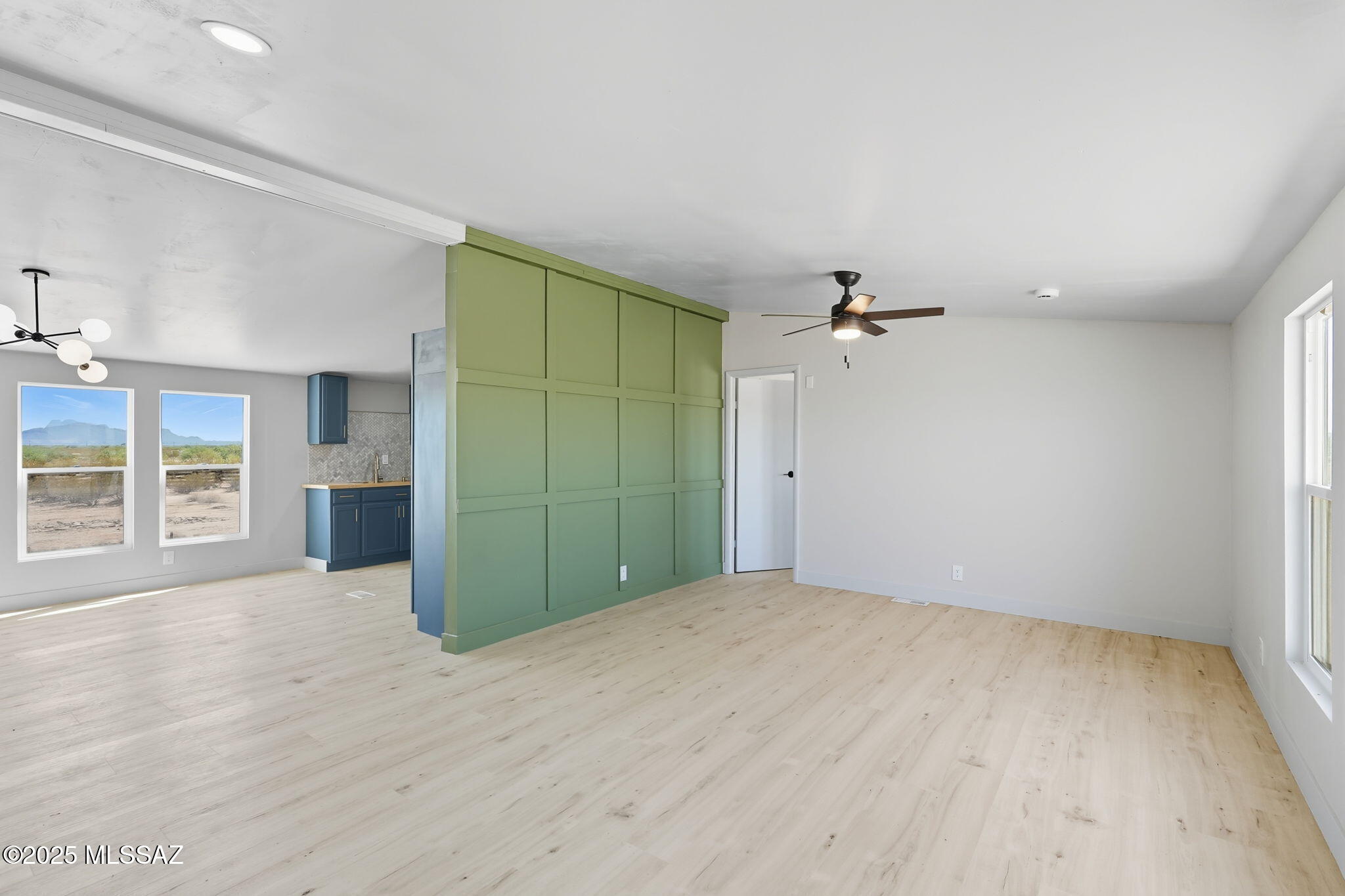 8790 North Trico Road Marana, AZ 85653 - Photo 4 of 35 an empty room with wooden floor and windows