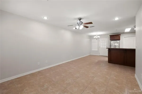 a view of an empty room with a kitchen