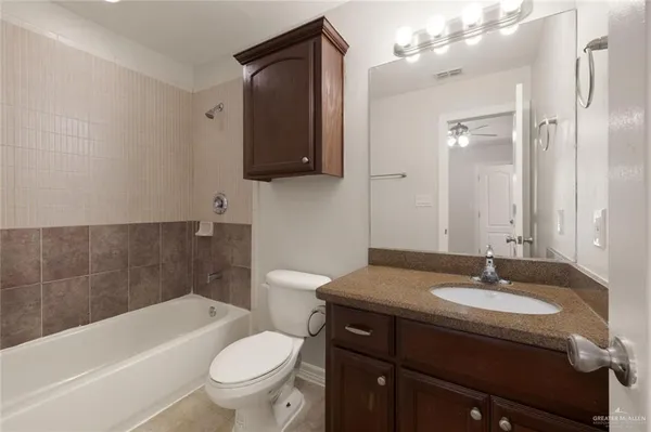a bathroom with a sink toilet a mirror and bathtub