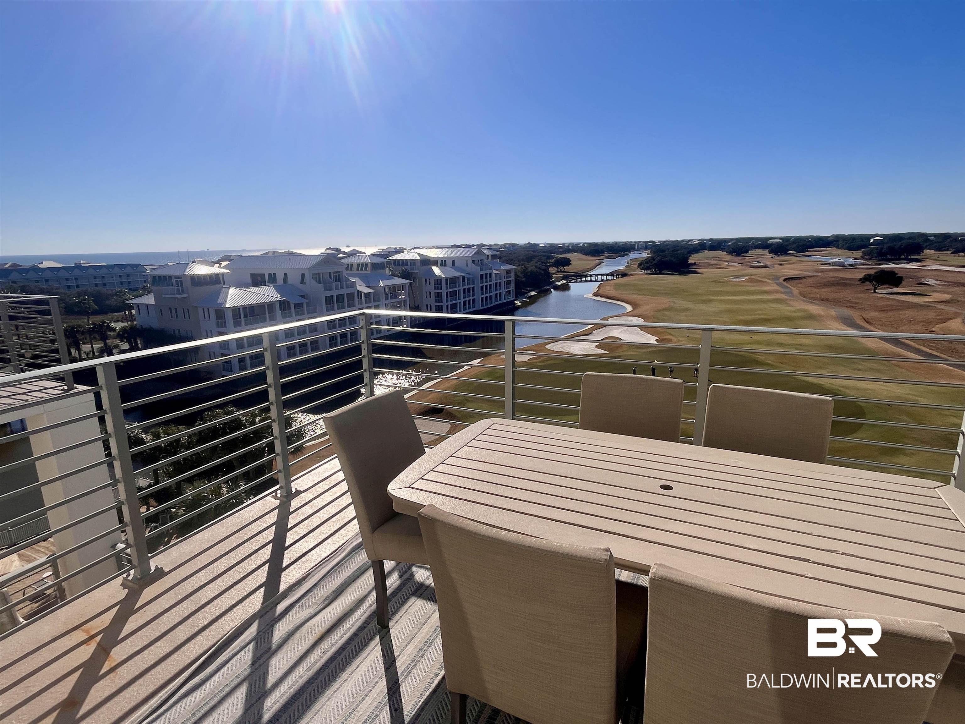 815 Plantation Road, Unit 604 Gulf Shores, AL 36542 - Photo 14 of 86 Balcony with a water view and outdoor dining area
