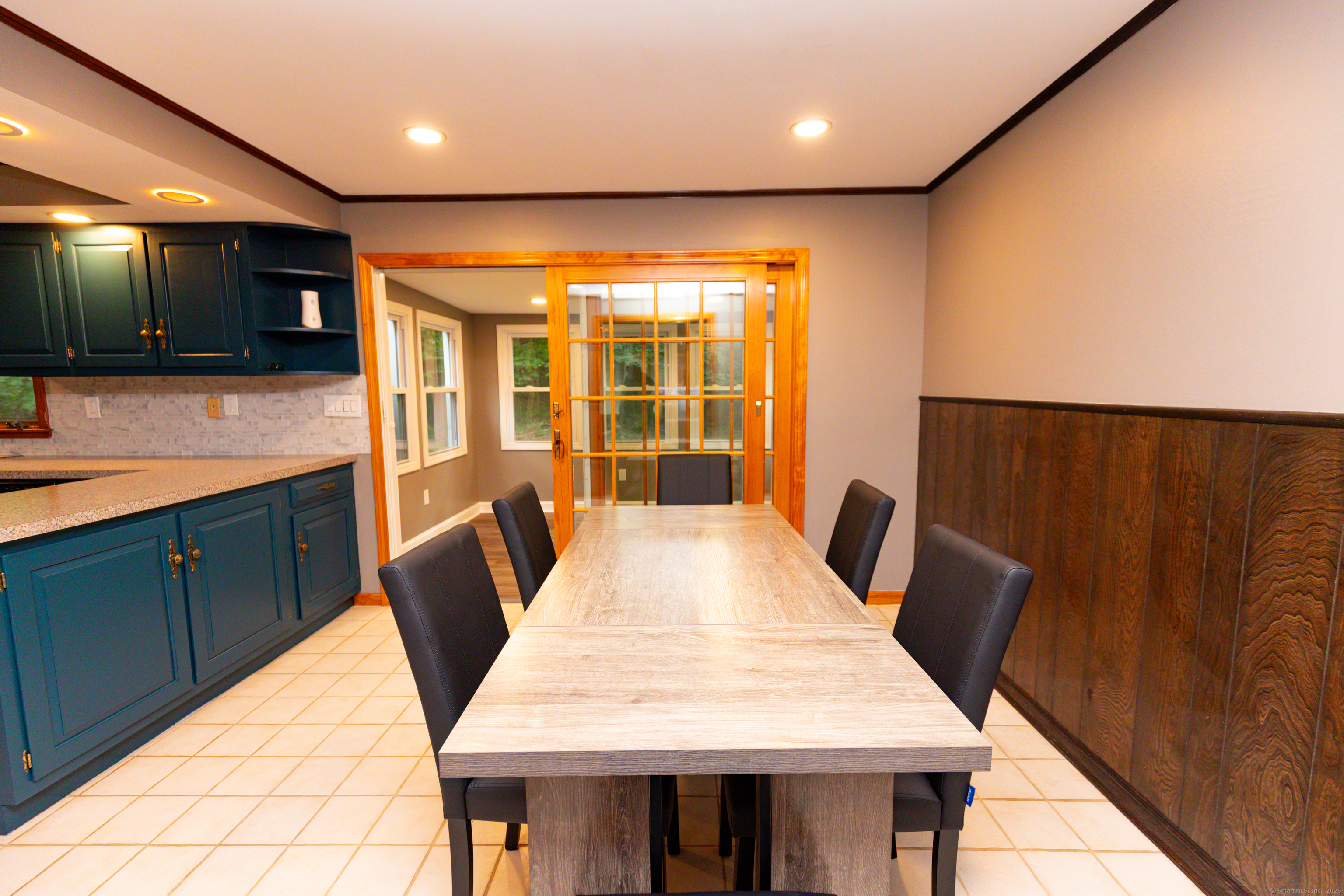 45 Renshaw Road Hamden, CT 06518 - Photo 11 of 26 a view of a kitchen with kitchen island a sink a large window and wooden floor