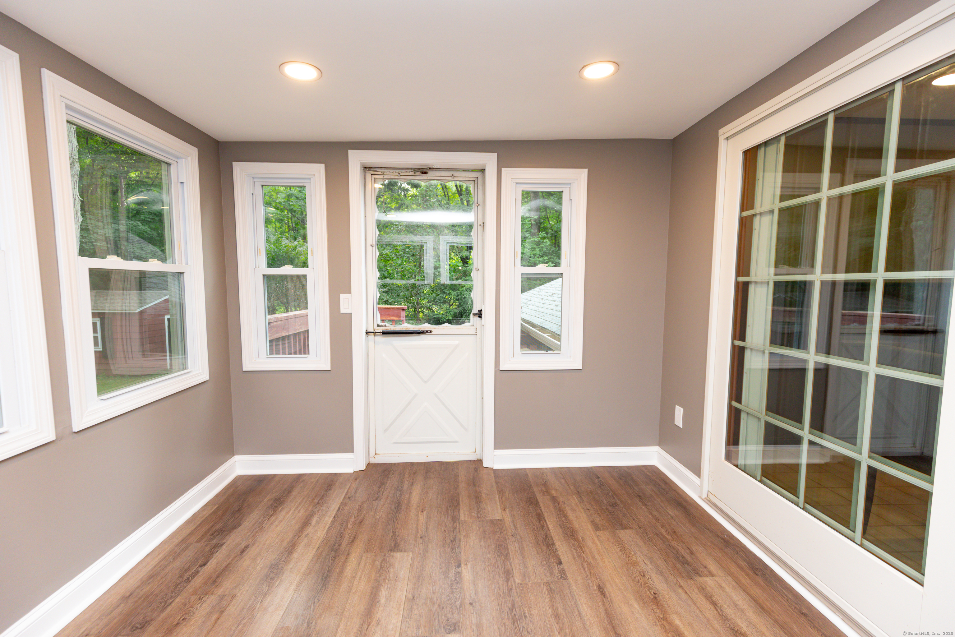 45 Renshaw Road Hamden, CT 06518 - Photo 13 of 26 an empty room with wooden floor and windows