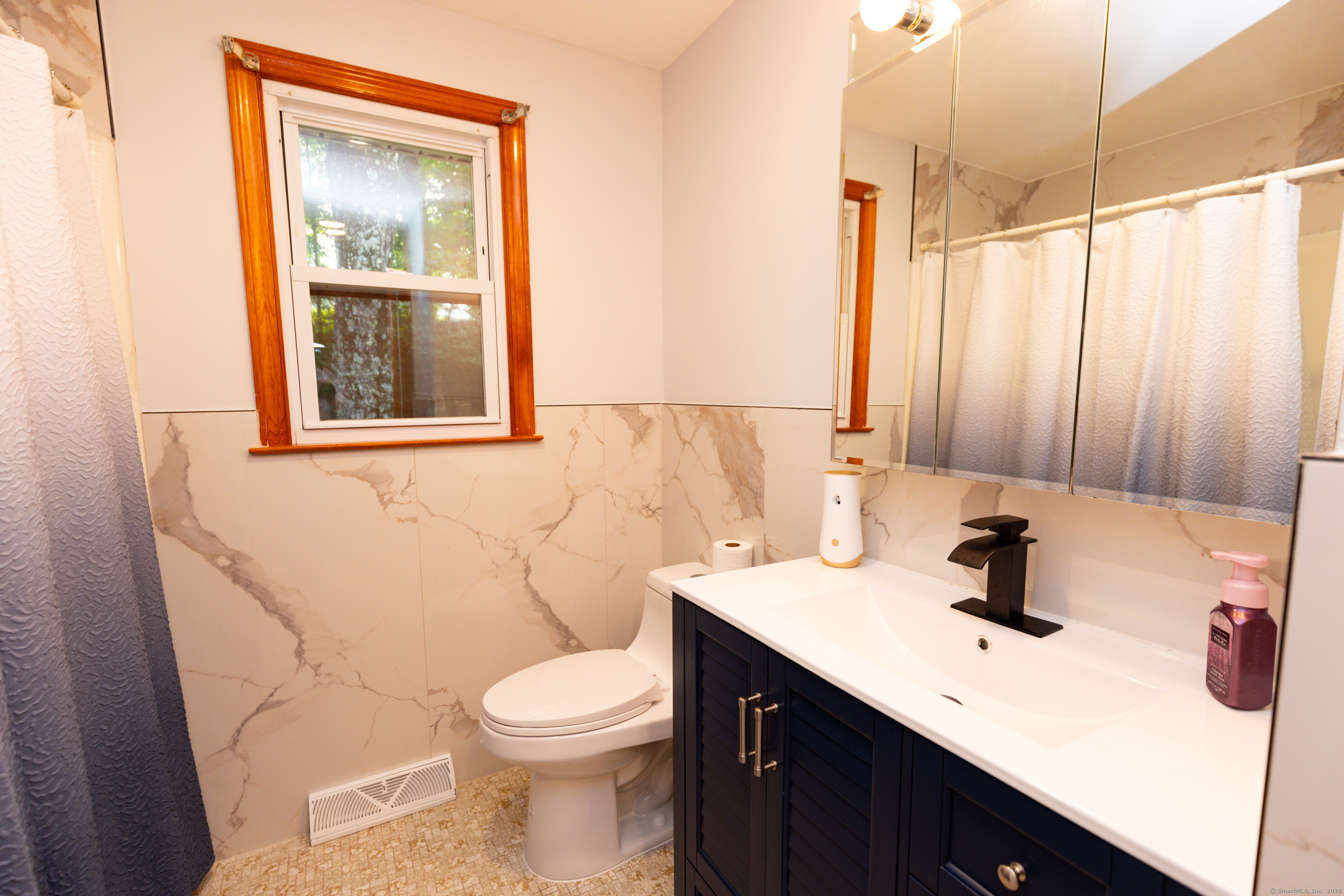 45 Renshaw Road Hamden, CT 06518 - Photo 24 of 26 a bathroom with a sink a toilet and mirror