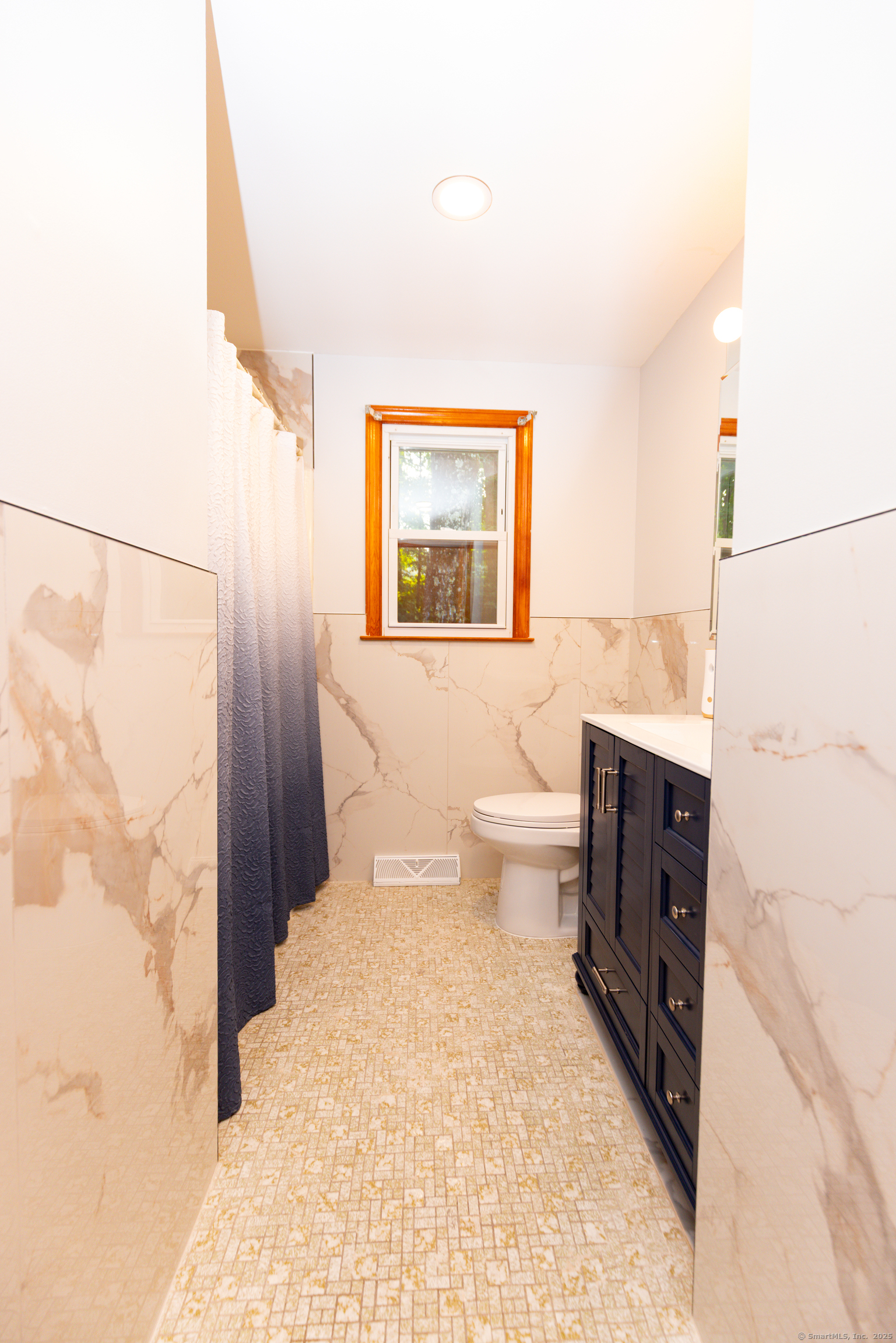 45 Renshaw Road Hamden, CT 06518 - Photo 25 of 26 a bathroom with a toilet sink and mirror