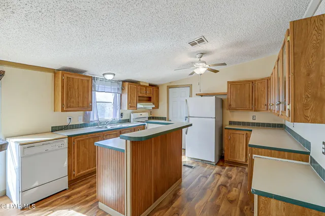 a kitchen with a sink cabinets and window