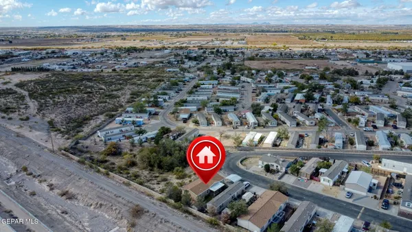 an aerial view of a house and a yard