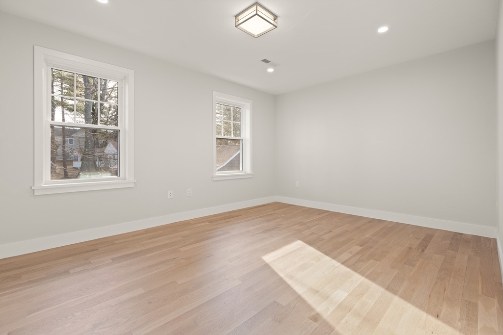 14 Benjamin Road Lexington, MA 02421 - Photo 20 of 35 an empty room with wooden floor and windows