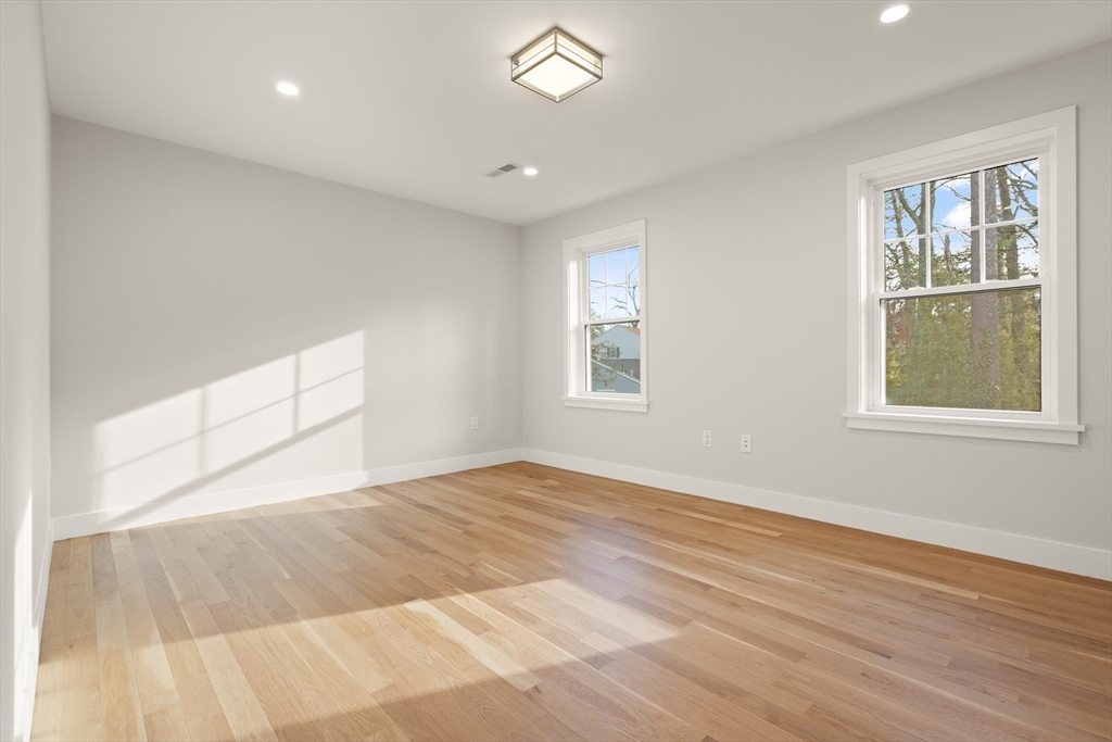 14 Benjamin Road Lexington, MA 02421 - Photo 21 of 35 a view of empty room with wooden floor and fan