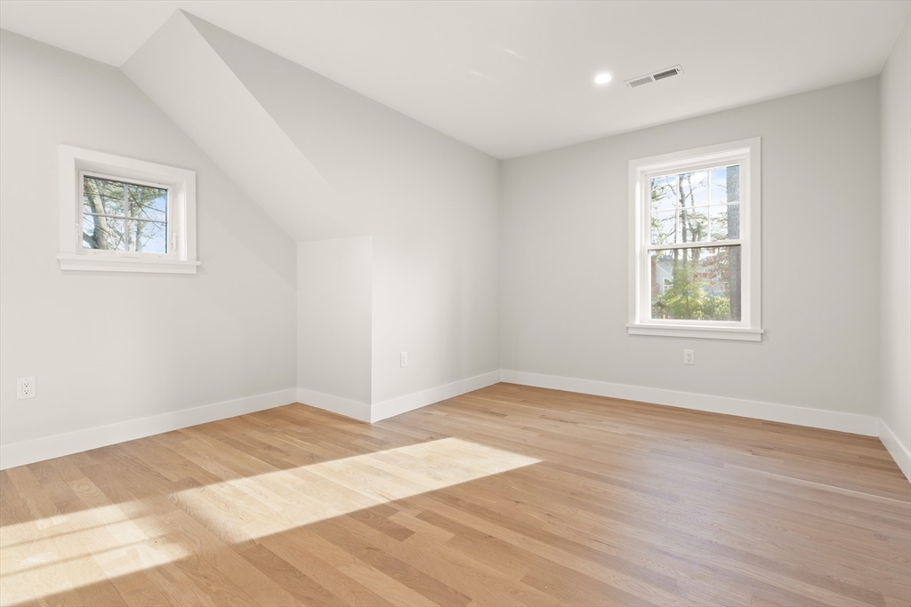 14 Benjamin Road Lexington, MA 02421 - Photo 22 of 35 a view of an empty room with wooden floor and a window