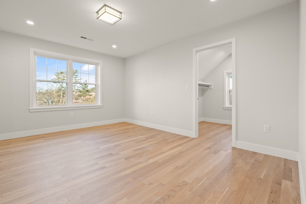 14 Benjamin Road Lexington, MA 02421 - Photo 23 of 35 an empty room with wooden floor and windows