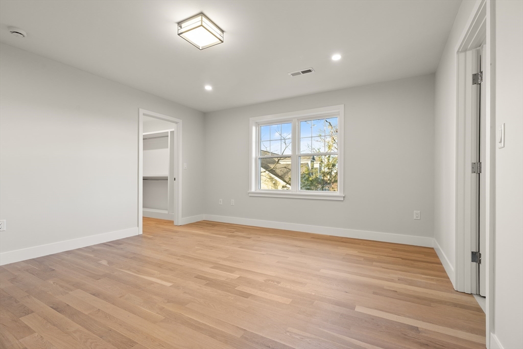 14 Benjamin Road Lexington, MA 02421 - Photo 24 of 35 wooden floor in an empty room with a window