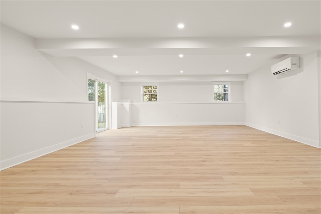 14 Benjamin Road Lexington, MA 02421 - Photo 25 of 35 an empty room with wooden floor and windows
