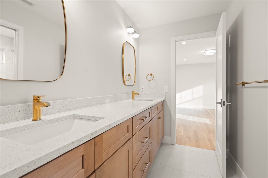 14 Benjamin Road Lexington, MA 02421 - Photo 26 of 35 a spacious bathroom with a double vanity sink and a mirror